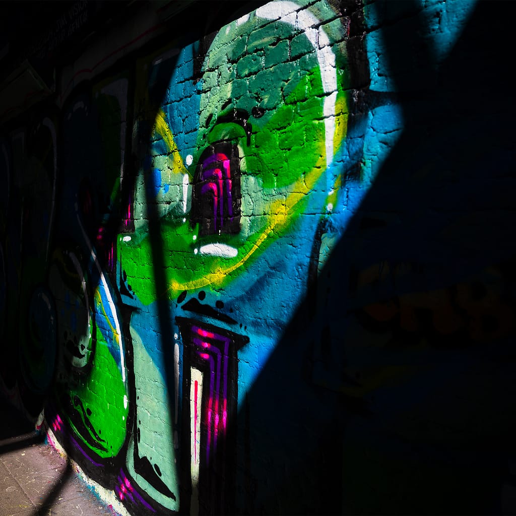 a wall with colorful graffiti