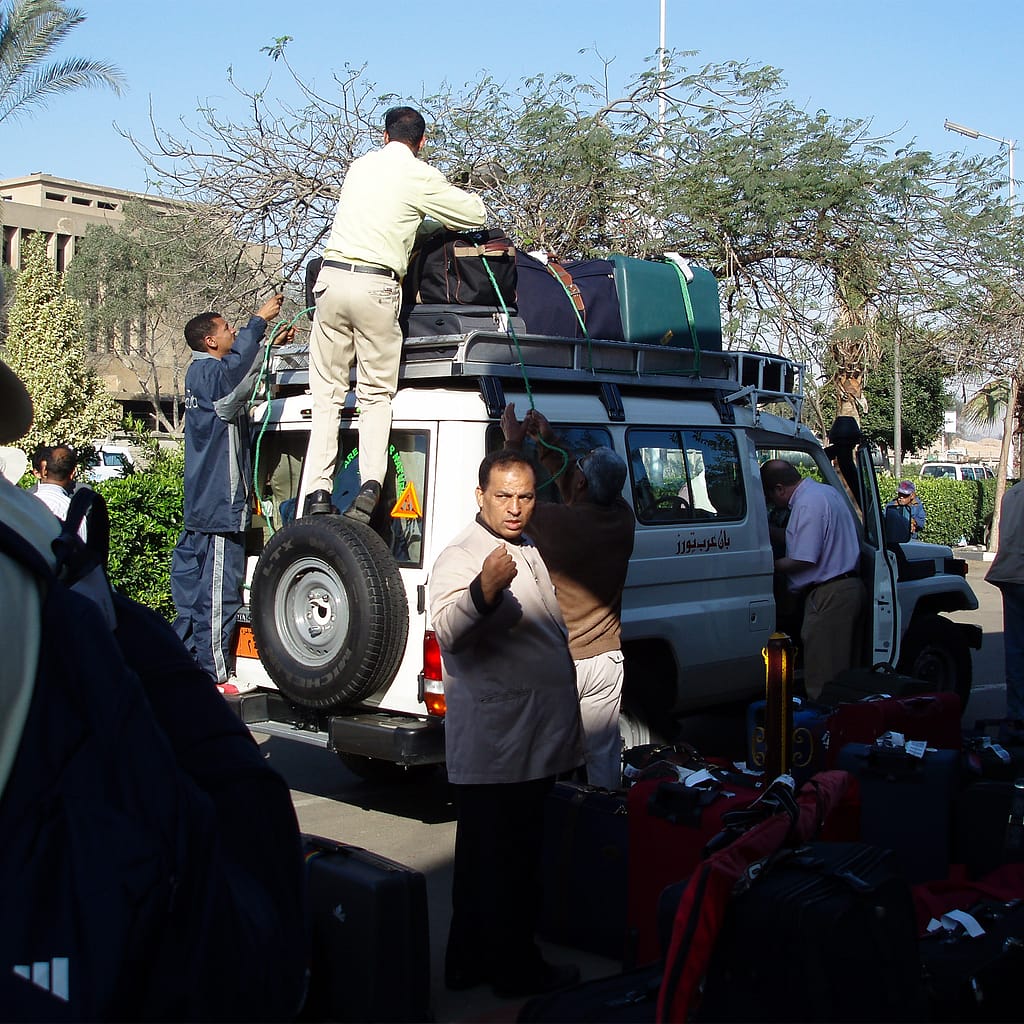 Egypt Eclipse Tour a group of people loading the top of a Landcruiser