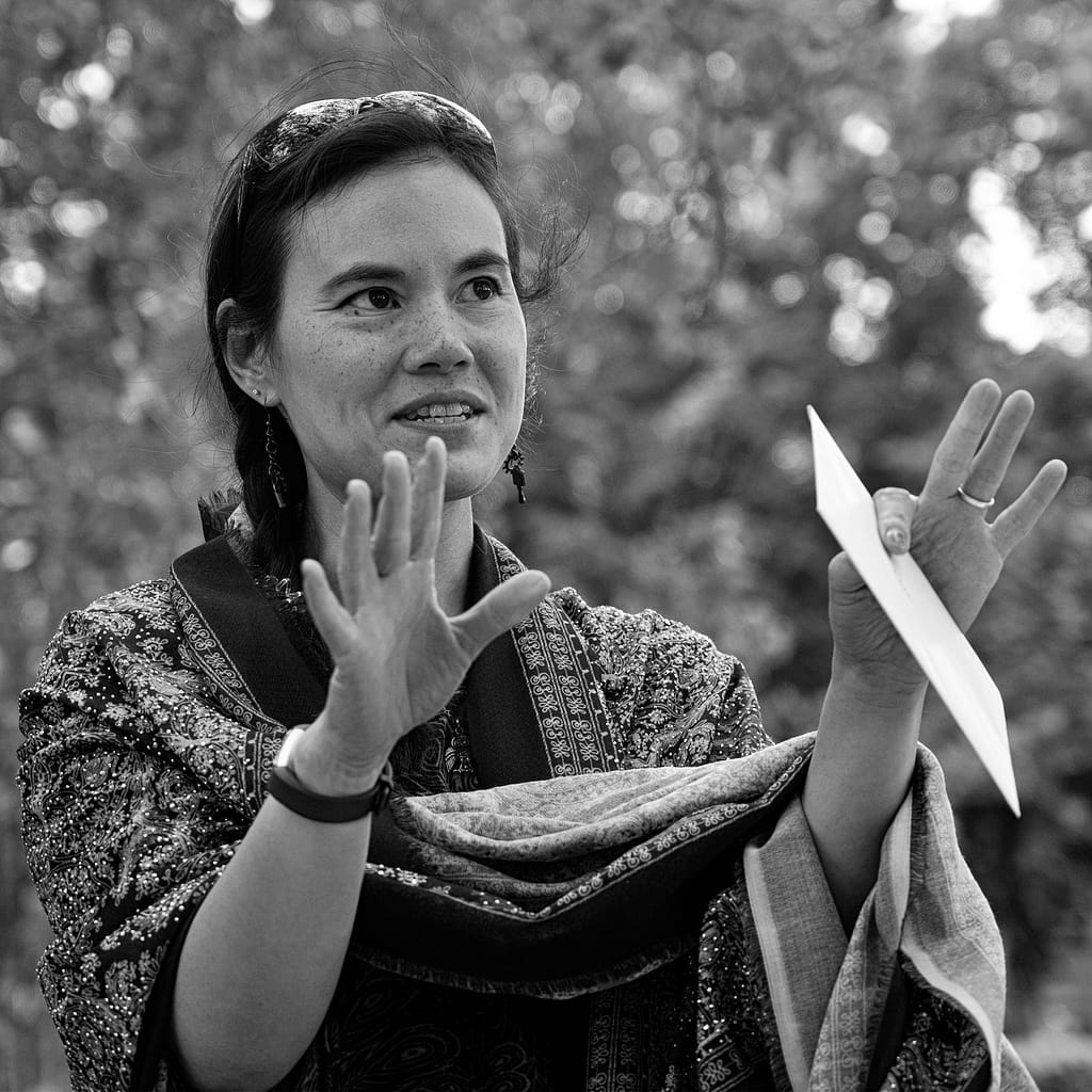 a woman holding a paper plane