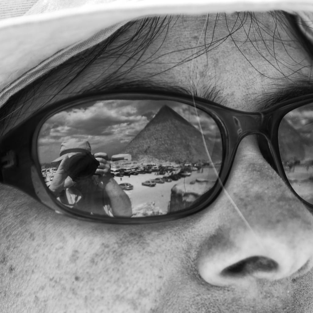 a person wearing sunglasses and taking a picture