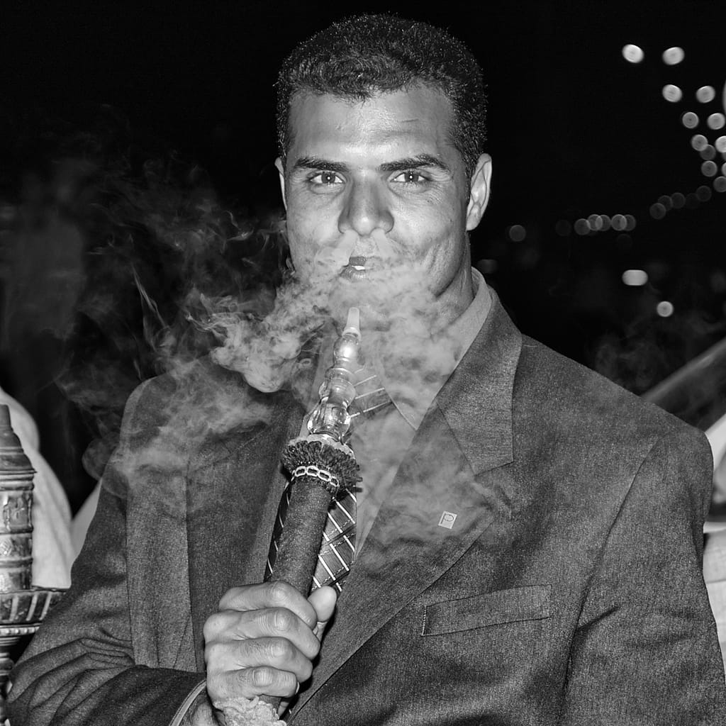a man smoking a hookah