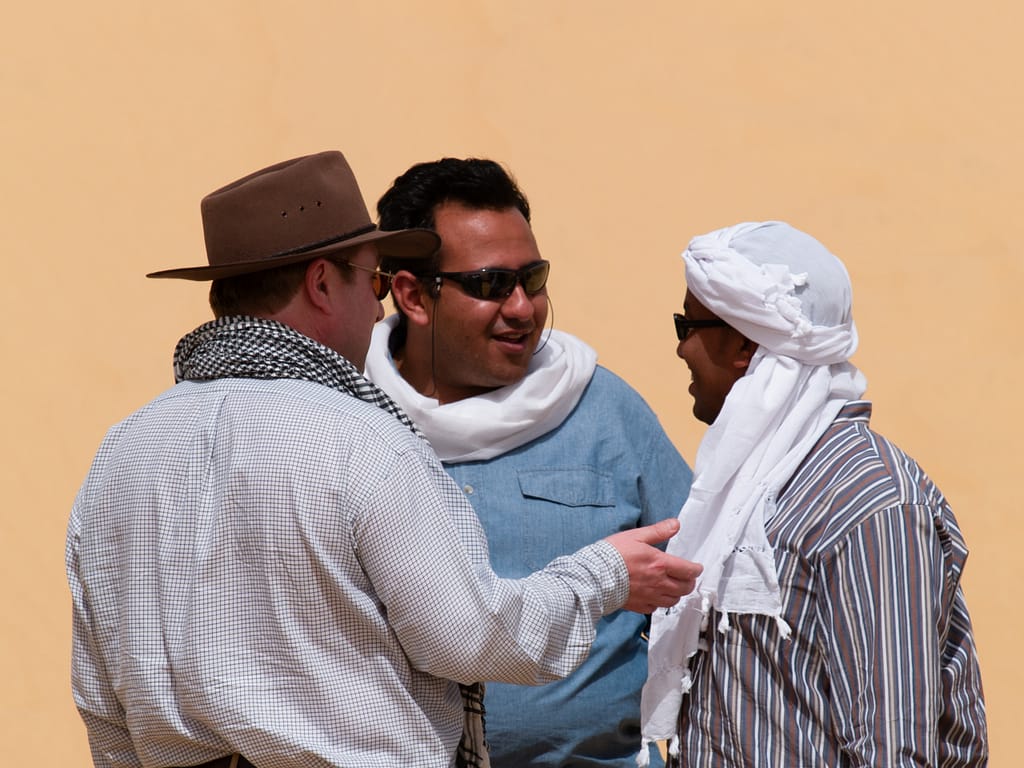 Egypt Eclipse Tour A group of men arguing in the desert
