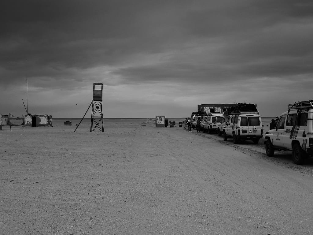 a group of vehicles parked in a desert - Egypt Eclipse Tour