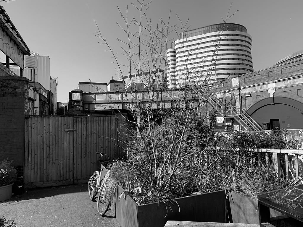 a bicycle parked in a courtyard with a building in the background
