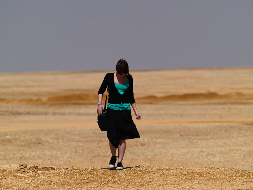 Egypt Eclipse Tour A Girl in Black walking across the desert