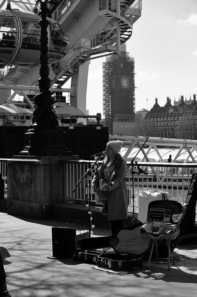 a woman playing a music on the south bank