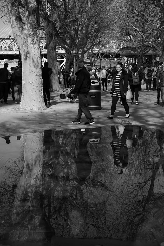 a group of people walking by the river